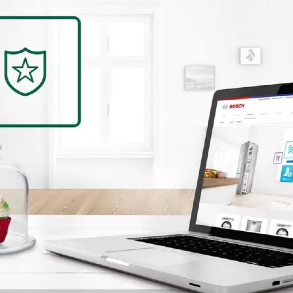 Laptop met Bosch website, afbeelding van een schild met ster, en een cupcake onder een glazen stolp.